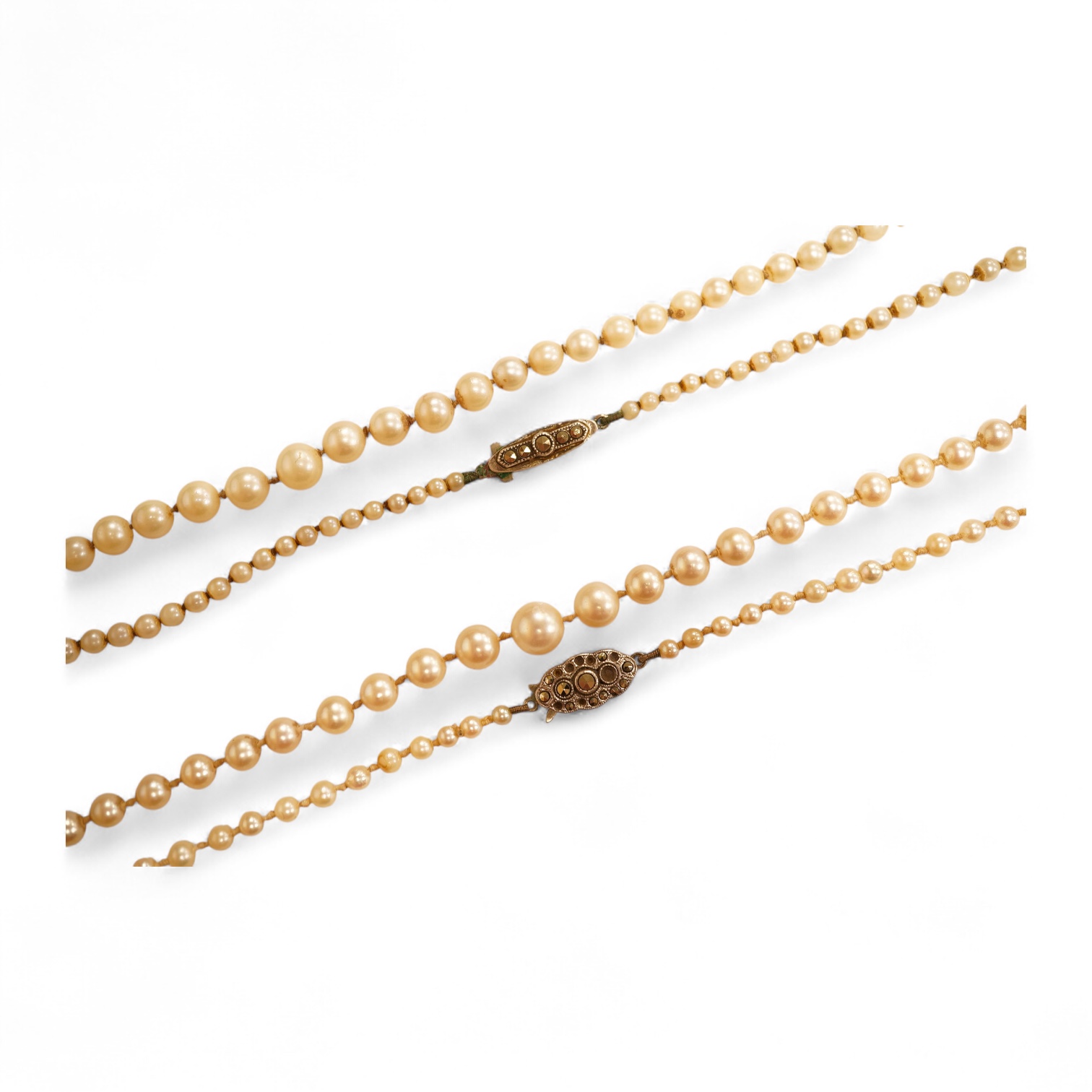 Two single strands graduated cultured pearl necklaces, both with marcasite set sterling clasps, longest, 64cm.